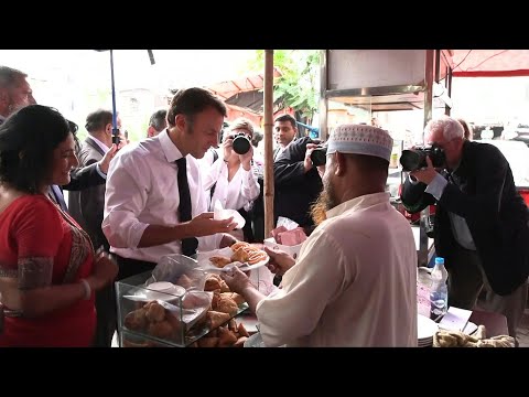 France's Macron samples local food in Bangladesh, takes boat trip | AFP
